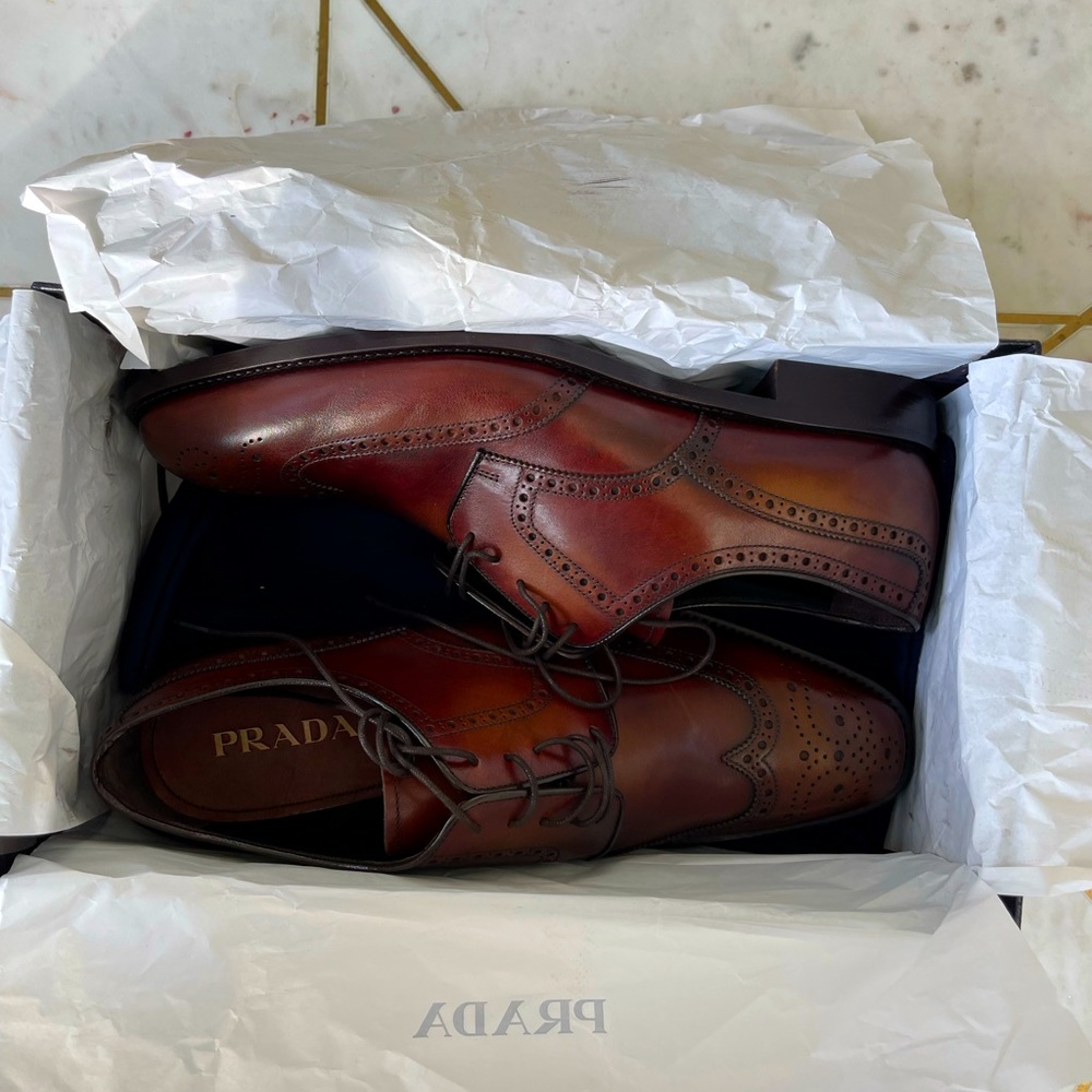 Brand new brown leather Prada shoes .